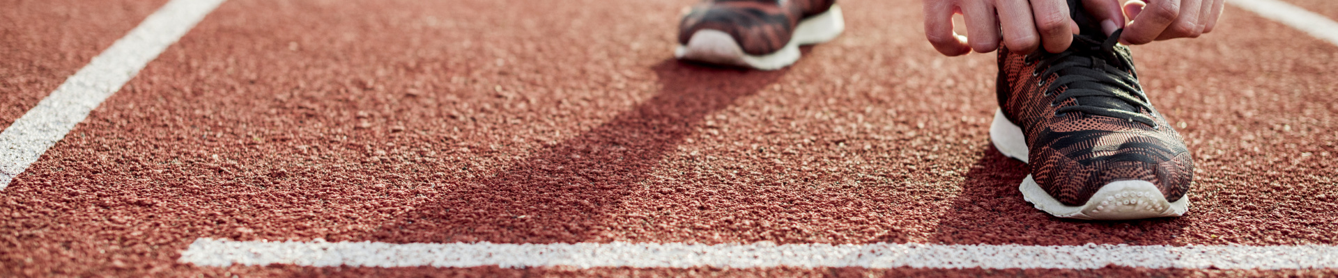 close-up-young-woman-tying-sports-shoe-red-race-track.jpg